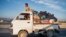 (FILES) In this photograph taken on November 12, 2023, Afghan refugees with their belongings sit atop a truck as they head from a makeshift camp near the Afghanistan-Pakistan Torkham border to Jalalabad, after their deportation from Pakistan, in the Ghani