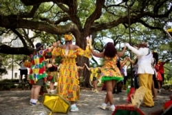 FILE - New Orleans baby dolls dance at the ancestor oak tree in Congo Square, in celebration of Juneteenth, a holiday that marks the end of U.S. slavery in 1865, in New Orleans, June 20, 2020. Juneteenth will soon be an official national holiday.