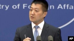 Firefighters inspect the damage at a building following a rocket attack on the city of Kyiv, Ukraine, in this handout photo taken from video released by Ukrainian Police Department Press Service.