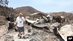 Steve Keeling walks through the ashes of his fire ravaged home in South Lake, California, June 27, 2016. 