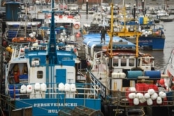 FILE - Fishing boats are moored at the South Pier of Bridlington Harbor fishing port in Bridlington, Dec. 11, 2020.