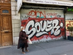 A woman wearing a face mask in Paris. Many Parisians opt for homemade cloth varieties.