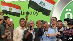 The Muslim Brotherhood's General Guide Mohammed Badie speaks onstage as military helicopters fly overhead before tens of thousands of supporters in Cairo, July 5, 2013.