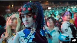 In this July 28, 2018 file photo, cosplayer fans watch the competition between Philadelphia Fusion and London Spitfire during the Overwatch League Grand Finals competition, at Barclays Center in the Brooklyn borough of New York. (AP Photo/Mary Altaffer, F