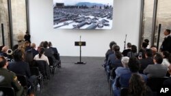 Invitees wait for the start of the inauguration ceremony of a floor made with melted weapons in Bogota, Colombia, July 31, 2018. 