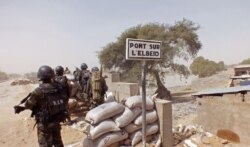 FILE- Cameroon soldiers stand guard at a lookout post as they take part in operations against the Islamic extremists group Boko Haram near the village of Fotokol, Feb. 25, 2015.