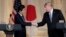 Japanese Prime Minister Shinzo Abe, left, and President Donald Trump shake hands during a news conference at Trump's private Mar-a-Lago club, April 18, 2018, in Palm Beach, Florida.