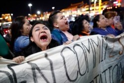 Protesters chant outside a campaign event for Democratic presidential candidate, former Vice President Joe Biden at Harbor Palace Seafood Restaurant in the Chinatown neighborhood of Las Vegas, Feb. 18, 2020.