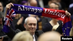 Members of the European Parliament react after voting on the Brexit deal during a plenary session at the European Parliament in Brussels, Belgium January 29, 2020. REUTERS/Yves Herman/Pool