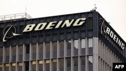 FILE - The Boeing Co. logo is displayed outside of company offices near Los Angeles International Airport (LAX) in El Segundo, California, Jan. 18, 2024. New CEO Kelly Ortberg laid out his plan to turn Boeing around after years of heavy losses and damage to its reputation.  