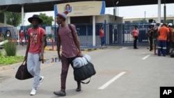 Students leave the campus at the North-West University in Mahikeng, South Africa, (also known as Mafikeng) Feb. 25, 2016. 