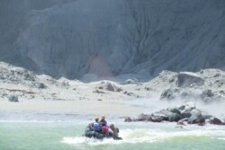Tour guides evacuate tourists on a boat shortly after the volcano eruption on White Island, New Zealand, Dec. 9, 2019 in this picture obtained from social media. (Credit:@SCH)
