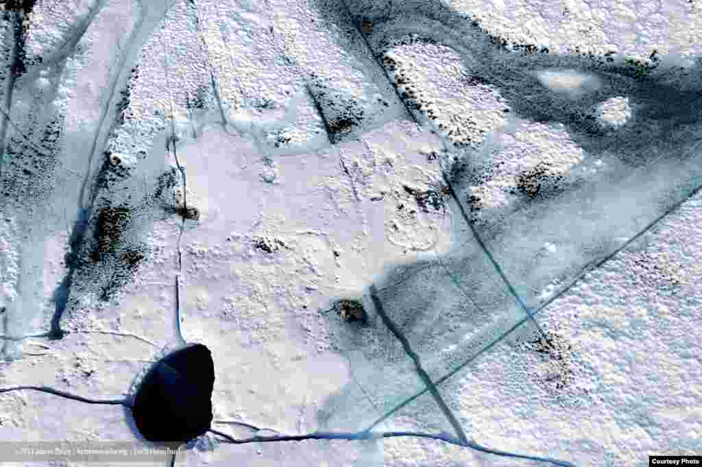 On Greenland&rsquo;s ice sheet, silt and soot blown from afar absorb solar heat and melt down into the ice. (James Balog/Extreme Ice Survey)