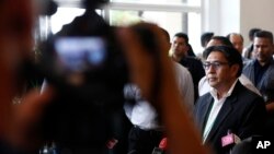 Malaysian Department of Civil Aviation, Azharuddin Abdul Rahman (R) speaks to the media after a closed door meeting with relatives of passengers on board the missing Malaysia Airlines flight MH370 at a hotel in Bangi, Malaysia, April 2, 2014.