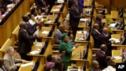Members of the ruling African National Congress applaud as the results are read of a no-confidence vote by MP's in parliament in Cape Town South Africa, Aug. 8, 2017.