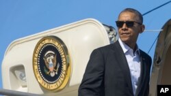 FILE - President Barack Obama boards Air Force One at Los Angeles International Airport, Feb. 12, 2016, in Los Angeles. Obama accepted the invitation to visit during a meeting with Vietnamese Prime Minister Nguyen Tan Dung on the sidelines of the U.S.-ASEAN Leaders summit in Rancho Mirage, California. 