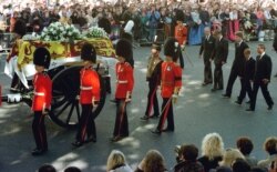 FILE - Guardsmen escort the coffin of Diana, Princess of Wales draped in the Royal Standard, as the cortege passes through crowds gathered along Whitehall.
