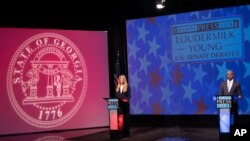Sen. Kelly Loeffler, left, and Democratic challenger for U.S. Senate Raphael Warnock appear during a debate, Dec. 6, 2020, in Atlanta. 