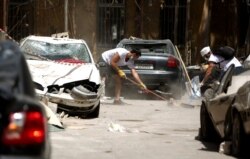 Volunteers clear the rubble in the Beirut neighborhood of Mar Mikhael, Aug. 14, 2020, more than a week after a massive blast ravaged the port and parts of the Lebanese capital.