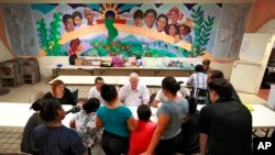Ruben Garcia, director of the Annunciation House, speaks with migrant parents, June 26, 2018, in El Paso, Texas