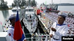FILE - Cambodian Navy sailors raise the Cambodian national flag on a Chinese naval patrol boat during a handover ceremony at a Cambodian naval base at Ream in Sihanouk Ville province, southwest of Phnom Penh, November 7, 2007.