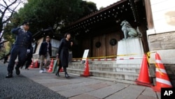 A police officer patrols around the Yasukuni shrine in Tokyo after an explosion went off, Nov. 24, 2015.