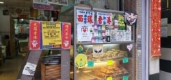 The shop front of Wah Yee Tang Bakery festooned with protest-related decorations.