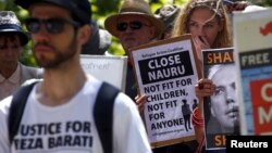 FILE - Protesters react as they hold placards and listen to speakers during a rally in support of refugees in central Sydney, Australia, Oct. 19, 2015. Australia said on April 3, 2016, it is no longer detaining asylum-seeking children on its mainland. 