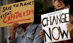 Demonstrators protest during a climate change strike in front of the St. Joseph Cathedral in Hanoi, Vietnam Sept. 27, 2019.