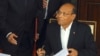 FILE - Tunisian President Moncef Marzouki reacts as he signs the new Constitution in Tunis, Jan. 27, 2014