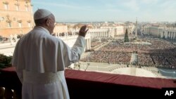 Pope Francis delivers his "Urbi et Orbi" (to the city and to the world) blessing from the central balcony of St. Peter's Basilica at the Vatican, Dec. 25, 2015. 