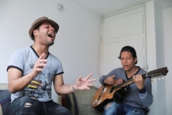 Venezuelan migrant Alexander Beja sings after an interview with Reuters in Soacha, Colombia, Aug. 23, 2019.