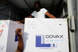 FILE - Boxes of AstraZeneca/Oxford coronavirus vaccines, redeployed from the Democratic Republic of Congo, arrive at a cold storage facility in Accra, Ghana, May 7, 2021.