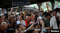 FILE - Supporters wave their hands at a sudden, unauthorized rally by the progressive Future Forward party in Bangkok, Thailand, Dec. 14, 2019.