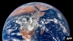 Members of the Asian Citizen's Center for Environment and Health perform during an Earth Day event against climate change at Gwanghwamun square in Seoul on April 22, 2020. 