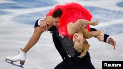 Russia's Ekaterina Bobrova (top) and Dmitri Soloviev compete during the figure skating ice dance short dance program at the Sochi 2014 Winter Olympics Feb. 16, 2014.