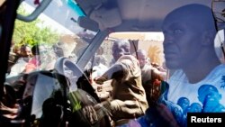 People surround a United Nations peacekeeper car during a protest against sending peacekeepers from Senegal to the northern rebel-held town of Kidal, before sending Malian soldiers there, in Gao, Mali, July 5, 2013.