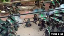 In a still image taken from not independently confirmed video, Chinese riot police are seen pushing against protesters in the coastal village of Wukan, in Guangdong province, China.