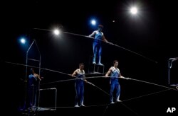 FILE - A Ringling Bros. and Barnum & Bailey high wire act performs in a show in 2017, in Orlando, Florida. (AP Photo/Chris O'Meara)