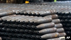 FILE - 155 mm M795 artillery projectiles are stacked during manufacturing process at the Scranton Army Ammunition Plant in Scranton, Pa., Thursday, April 13, 2023. 
