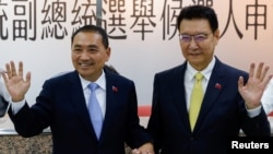 FILE - Hou Yu-ih, candidate for Taiwan's presidency from the main opposition party KMT, and Jaw Shaw-Kong, vice presidential candidate, make a campaign appearance in Taipei on Nov. 24, 2023. Analysts say China's goal is to help KMT win the Jan. 13 elections.