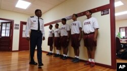 In this Thursday, Sept. 8, 2016 photo, Master Sgt. Fletcher Bailey inspects cadets before a junior ROTC class at the New York Military Academy in Cornwall-on-Hudson, N.Y. (AP Photo/Mike Groll)
