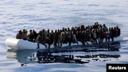 Migrants are seen in a rubber dinghy as they are rescued by the Libyan coast guard in the Mediterranean Sea off the coast of Libya, Jan. 15, 2018. 