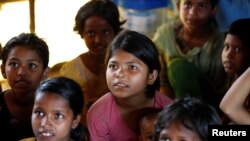 កុមារជនភៀសខ្លួន​កំពុង​ផ្ទៀង​ស្តាប់​គ្រូ​ខណ​ដែល​ពួកគេ​កំពុង​រៀននៅ​ក្នុង​ជំរំ​ជនភៀស​ខ្លួន Balukhali ទីក្រុង​Cox's Bazar ប្រទេស​បង់ក្លាដែស កាលពី​ថ្ងៃទី​១០ ខែ មេសា ឆ្នាំ ២០១៧។