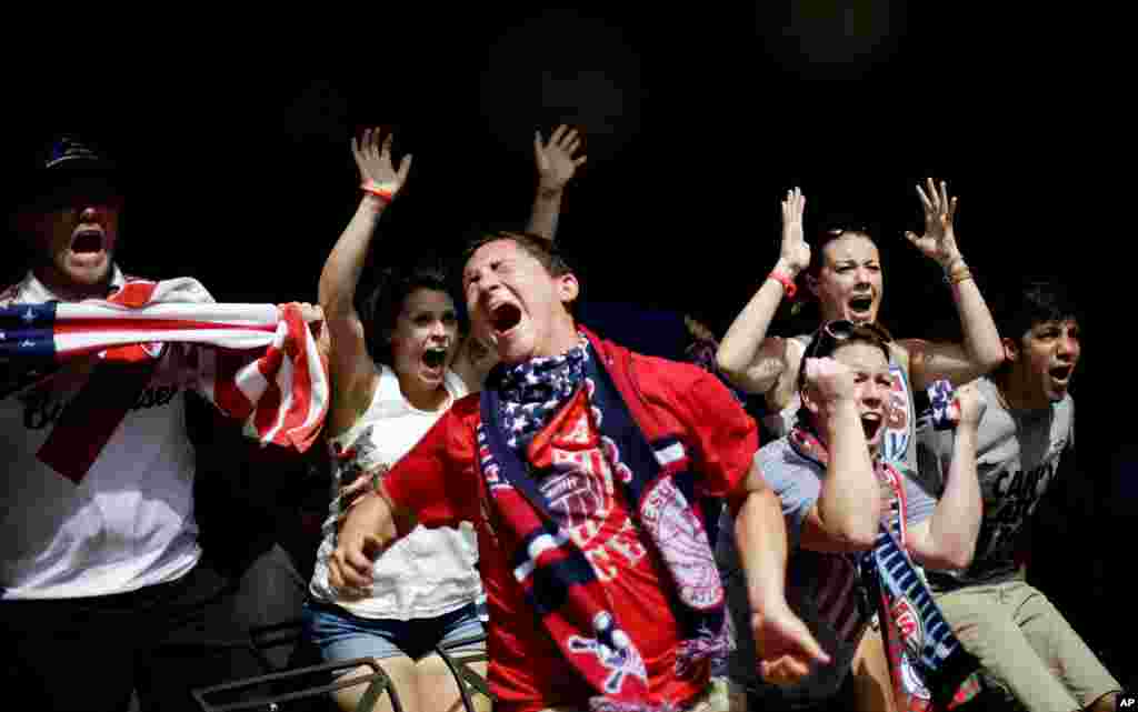 Harrison Heiman and Lindsay Heiman react with fellow fans while watching the 2014 World Cup soccer match between the United States and Belgium at a viewing party in Atlanta, July 1, 2014.