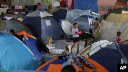 FILE - Tents fill the Tancredo Neves Gymnasium that is operating as a shelter for Venezuelans in Boa Vista, Roraima state, Brazil, March 8, 2018.
