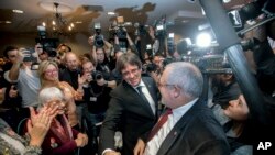 Observed by the media Ousted Catalan president Carles Puigdemont arrives for a presentation of the candidate list for the Catalan regional elections in Oostkamp, Belgium, Saturday, Nov. 25, 2017.
