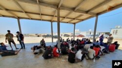 Rescued migrants rest near the city of Khoms, around 120 kilometers (75 miles) east of Tripoli, Libya, Aug. 27, 2019.