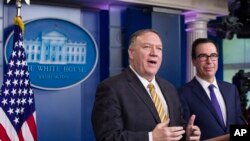 FILE - U.S. Secretary of State Mike Pompeo and Treasury Secretary Steve Mnuchin speak during a briefing at the White House, in Washington, Sept. 10, 2019. 