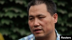 FILE - Chinese human rights lawyer Pu Zhiqiang faces trial Monday for allegedly using social media to incite hatred and violence. He's shown in Beijing, July 20, 2012.